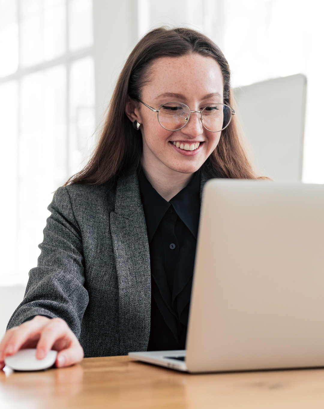 Smiling professional working on a laptop